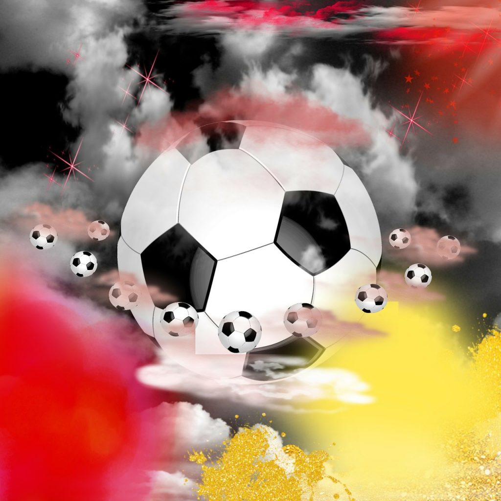 Ein Fußball inmitten schwarz-rot-goldener Atmosphäre, umkreist von weiteren Fußbällen