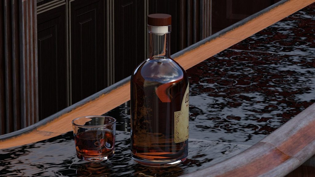 Schluss gemacht mit dem Alkohol: Eine Flasche Whisky mit Glas steht im Regen