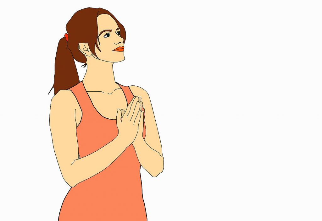 Eine junge Frau, die die Hände betend zusammenlegt und mit offenem Blick nach rechts schaut